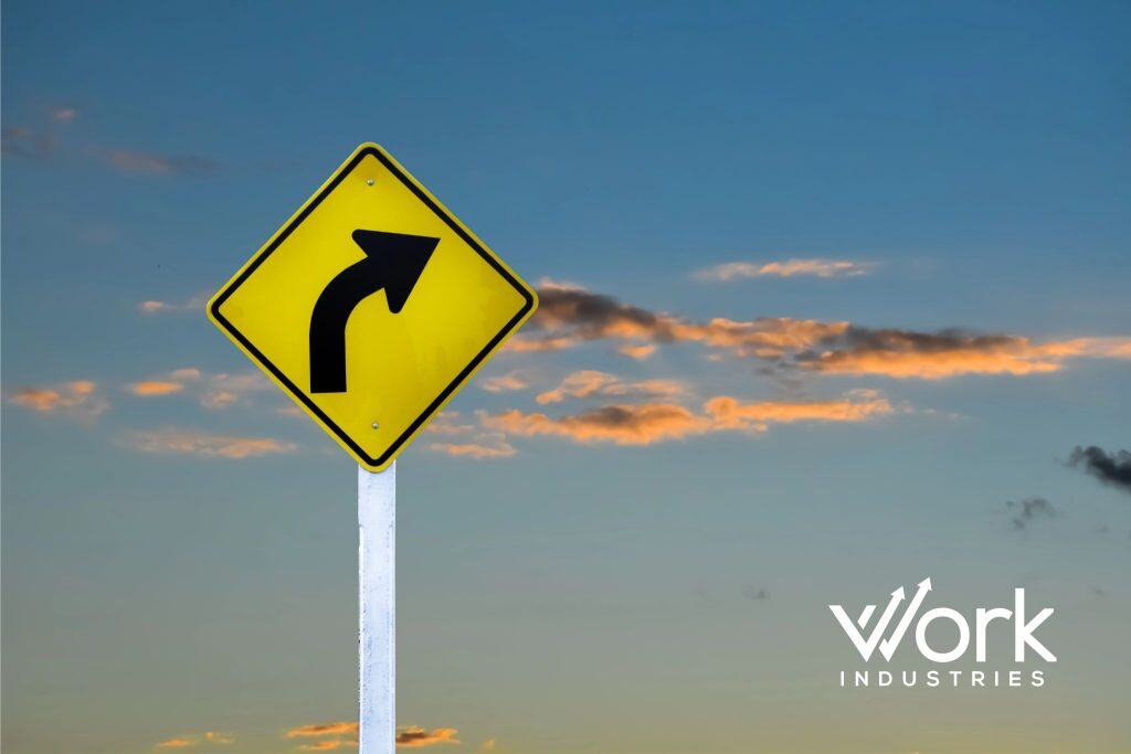 Road sign indicating a change in direction representing business turnaround and leadership transformation